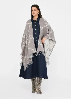 Poncho con logo e frange